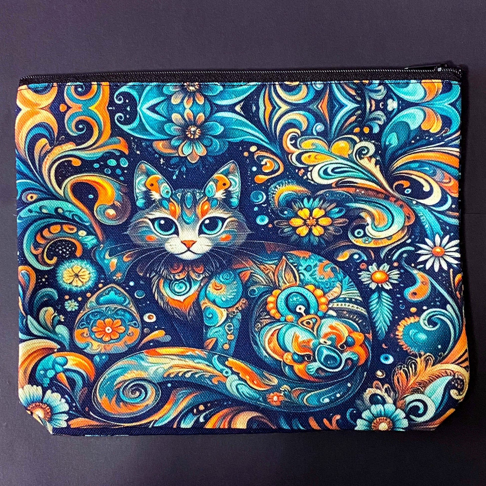 decorative folk art cat zipper canvas pouch featuring bright turquoise, navy and orange swirling floral patterns on a dark blue background. uk cute magical letterbox gifts shop. journaling pouch or pencil case.