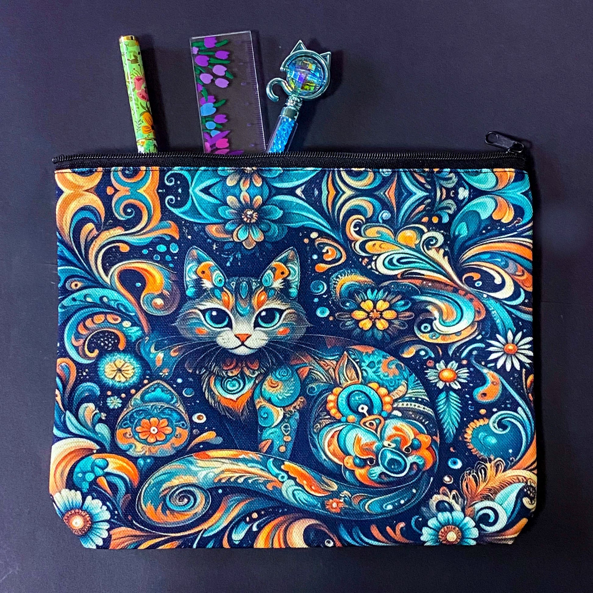 decorative folk art cat zipper canvas pouch featuring bright turquoise, navy and orange swirling floral patterns on a dark blue background. uk cute magical letterbox gifts shop. 