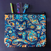 decorative folk art cat zipper canvas pouch featuring bright turquoise, navy and orange swirling floral patterns on a dark blue background. uk cute magical letterbox gifts shop. 