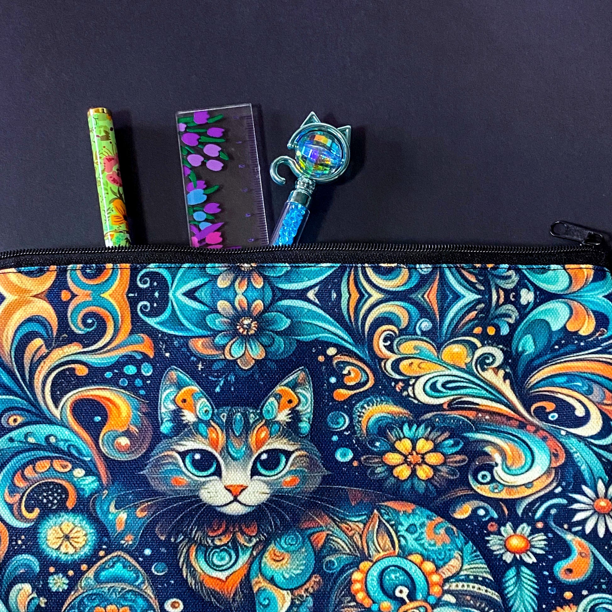 decorative folk art cat zipper canvas pouch featuring bright turquoise, navy and orange swirling floral patterns on a dark blue background. uk cute magical letterbox gifts shop. 