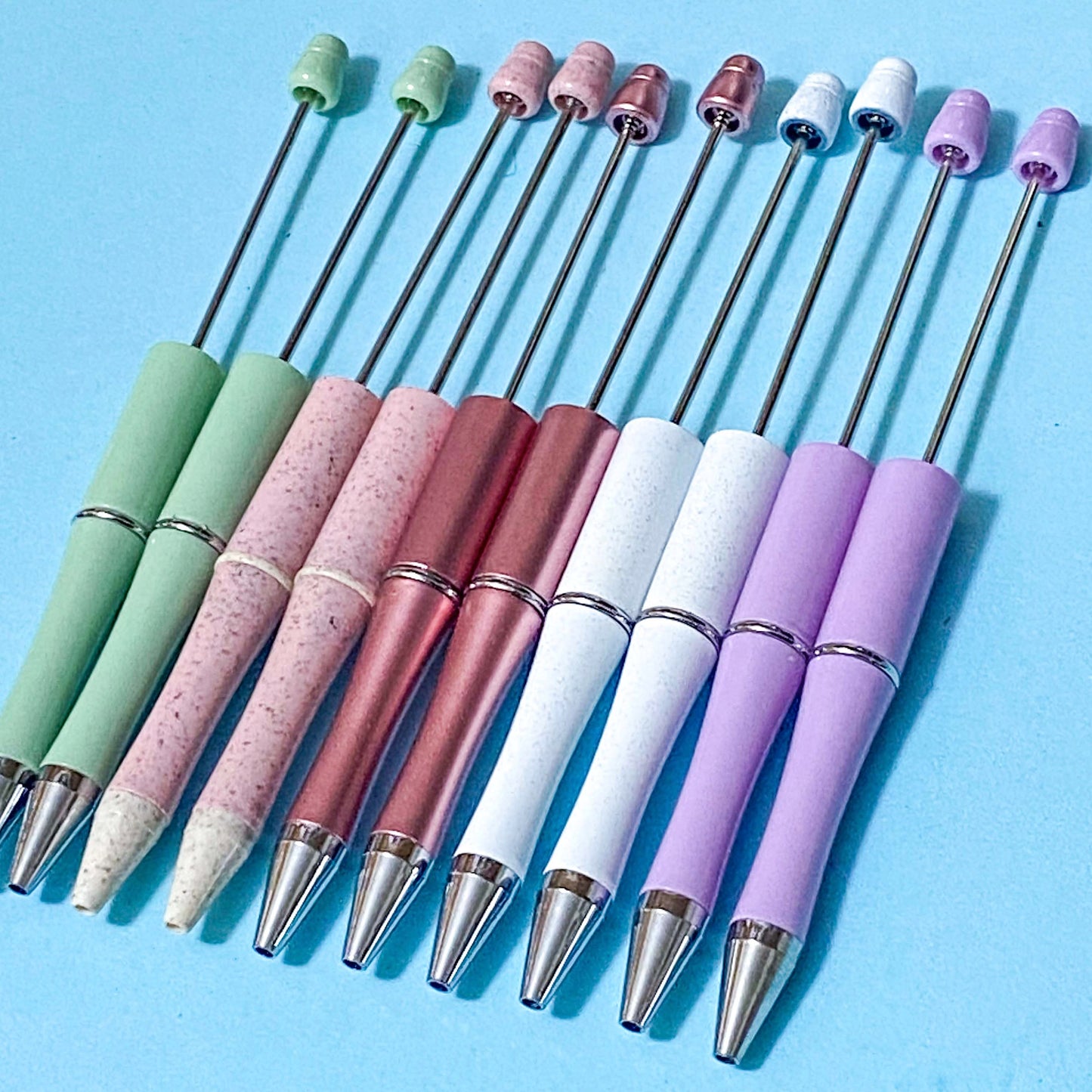pastel coloured pen blanks on a blue background