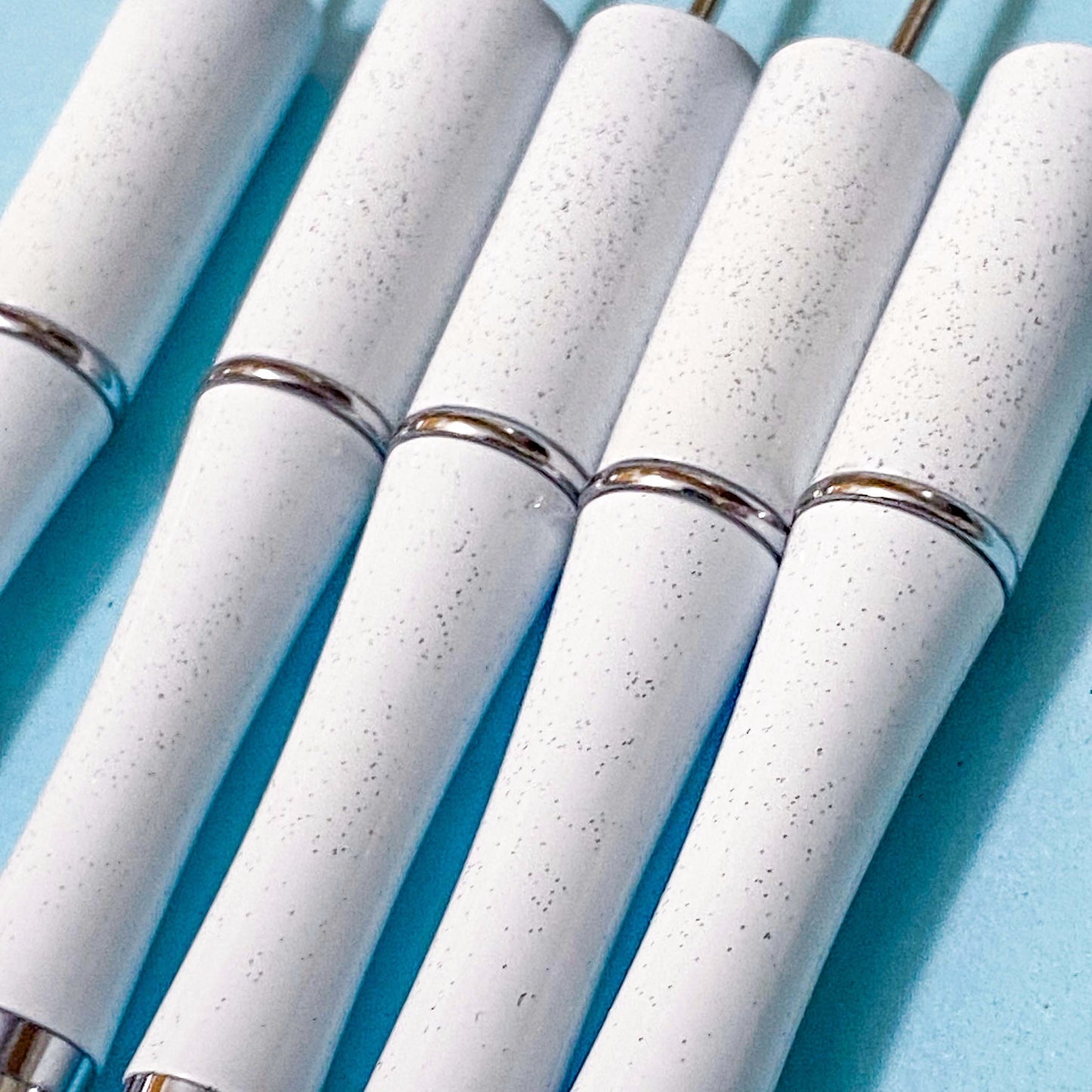 glittery white pen blanks on a blue background