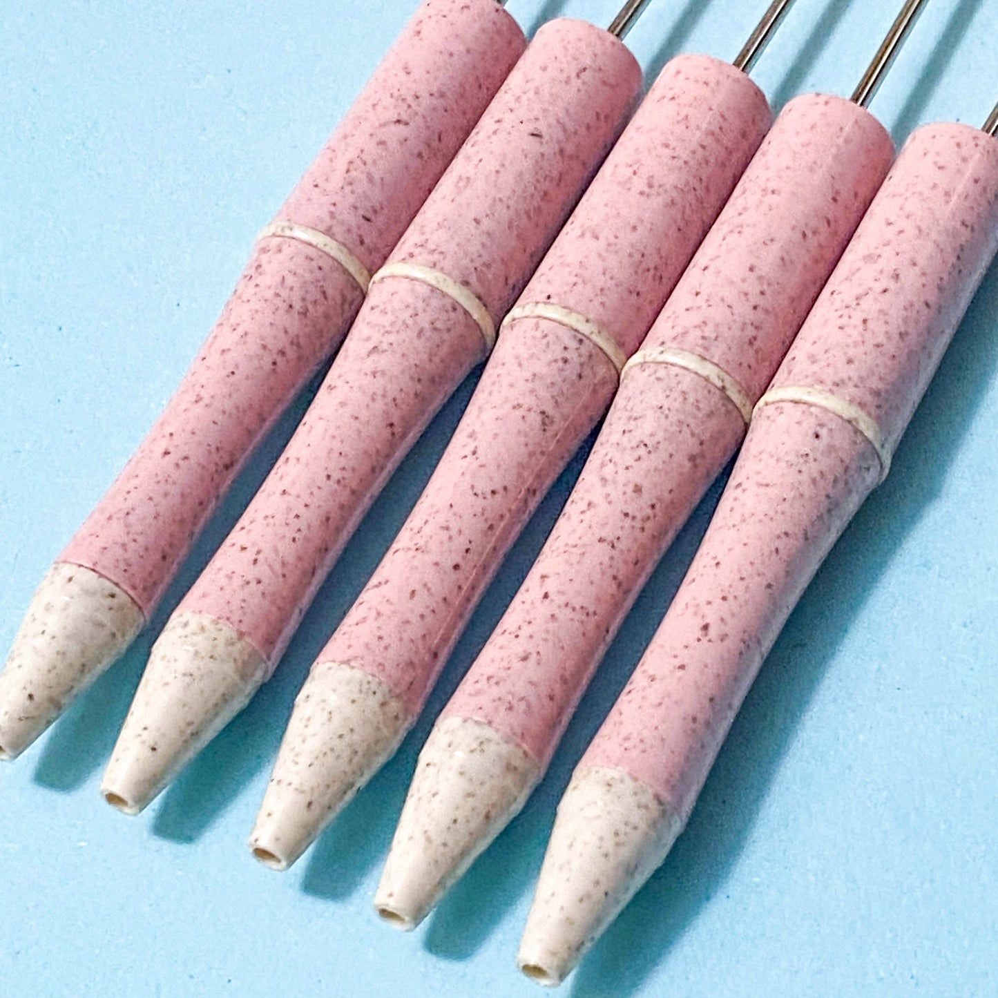 pale pink and cream speckled pen blanks on a blue background