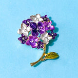 Floral hydrangea  brooch with purple and silver flowers on a blue background