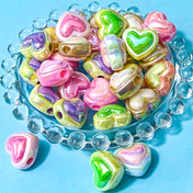large 19mm acrylic pearly heart shaped beads with a large hole on a blue background
