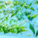 lily of the valley green and white flower stickers on a blue background