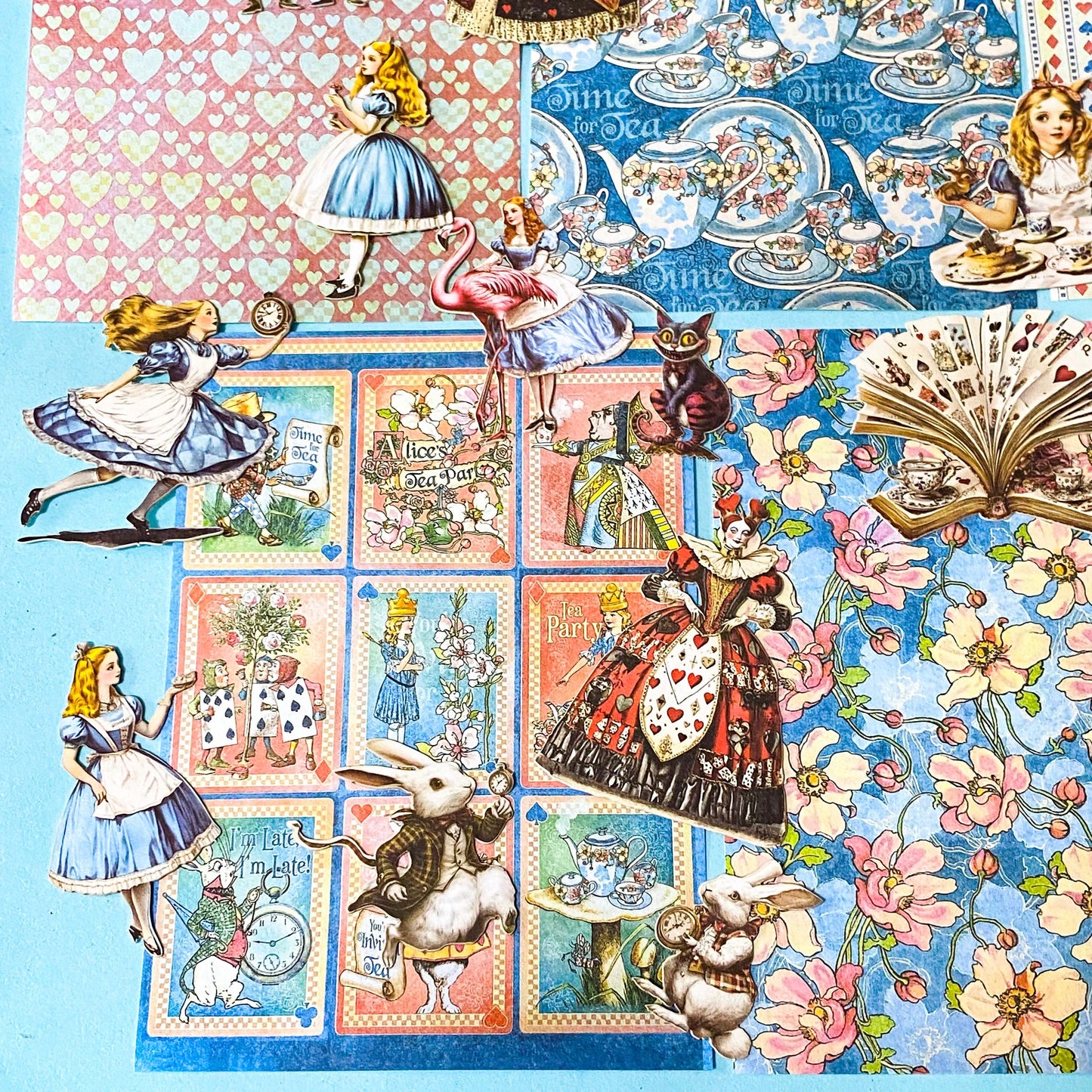 alice in wonderland ephemera sticker pack with scrapbook papers, die cut card stickers in a tea party theme with the write rabbit, queen of hearts, alice and cheshire cat decals