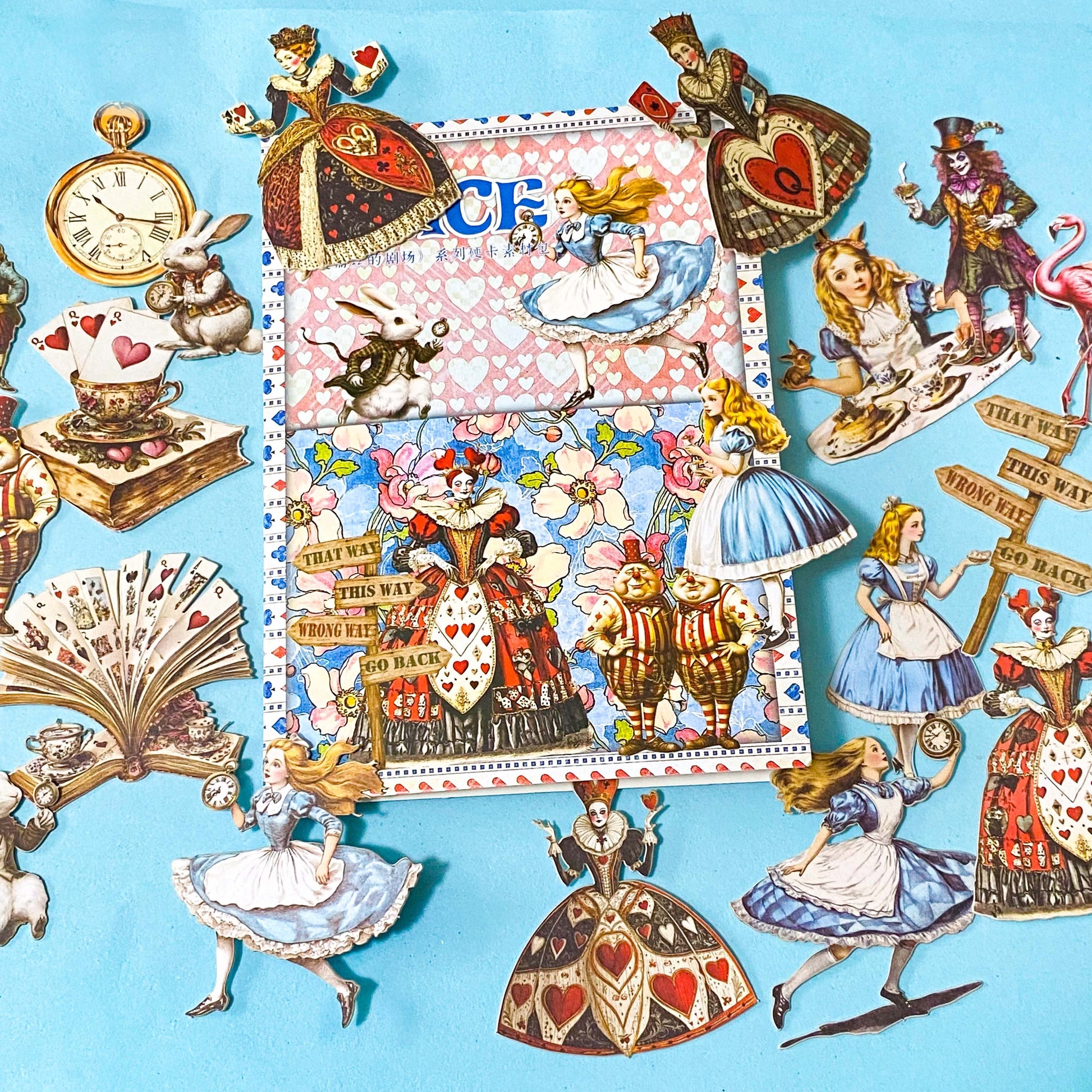 alice in wonderland ephemera sticker pack with scrapbook papers, die cut card stickers in a tea party theme with the write rabbit, queen of hearts, alice and cheshire cat decals