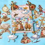alice in wonderland ephemera sticker pack with scrapbook papers, die cut card stickers in a tea party theme with the write rabbit, queen of hearts, alice and cheshire cat decals