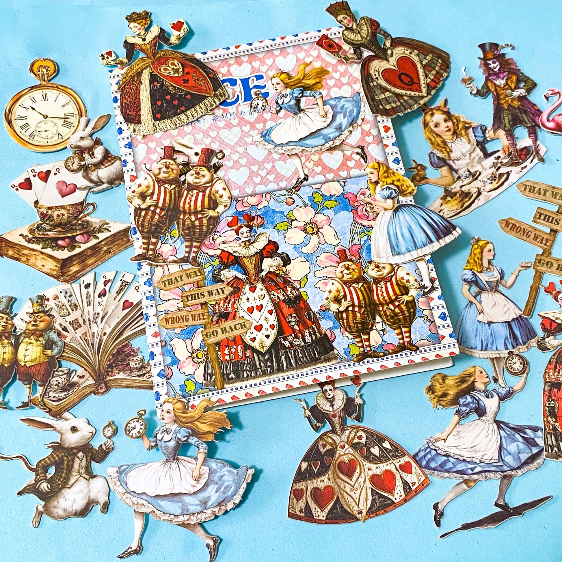 alice in wonderland ephemera sticker pack with scrapbook papers, die cut card stickers in a tea party theme with the write rabbit, queen of hearts, alice and cheshire cat decals