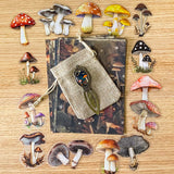 mushroom themed gift set with lined canvas pouch, vintage style bookmark, woodland scrapbook papers and clear mushroom stickers on wooden background