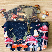 mushroom themed gift set with lined canvas pouch, vintage style bookmark, woodland scrapbook papers and clear mushroom stickers on wooden background