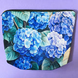 blue hydrangea letterbox gift set with canvas floral pouch, hydrangea black ink pen, enamel blue flower metal brooch, vintage botanical postcards and clear hydrangea stickers. uk cute gifts shop.