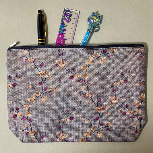 autumn hedgerow floral canvas pouch with taupe background, creamy flowers and burgundy rose hips, zip fastening and textured fabric. For journaling, pencil case or cosmetic bag. Uk gifts shop.