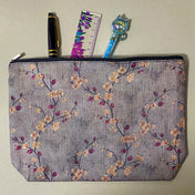 autumn hedgerow floral canvas pouch with taupe background, creamy flowers and burgundy rose hips, zip fastening and textured fabric. For journaling, pencil case or cosmetic bag. Uk gifts shop.