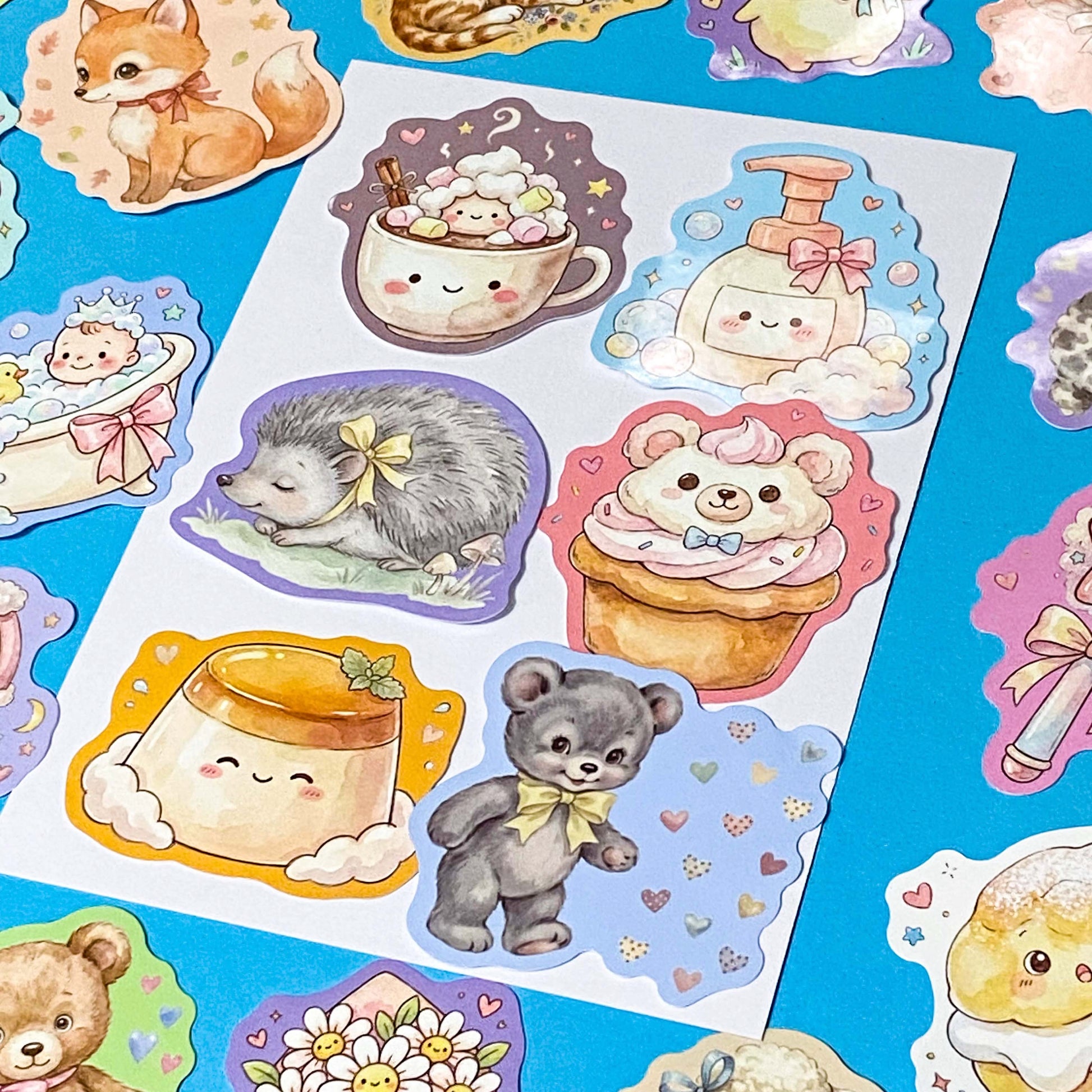 pack of 50 glossy pastel storybook stickers featuring baby animals, woodland creatures, sweet desserts and cakes, cosy drinks and whimsical kawaii illustrations, approx 53mm each. 