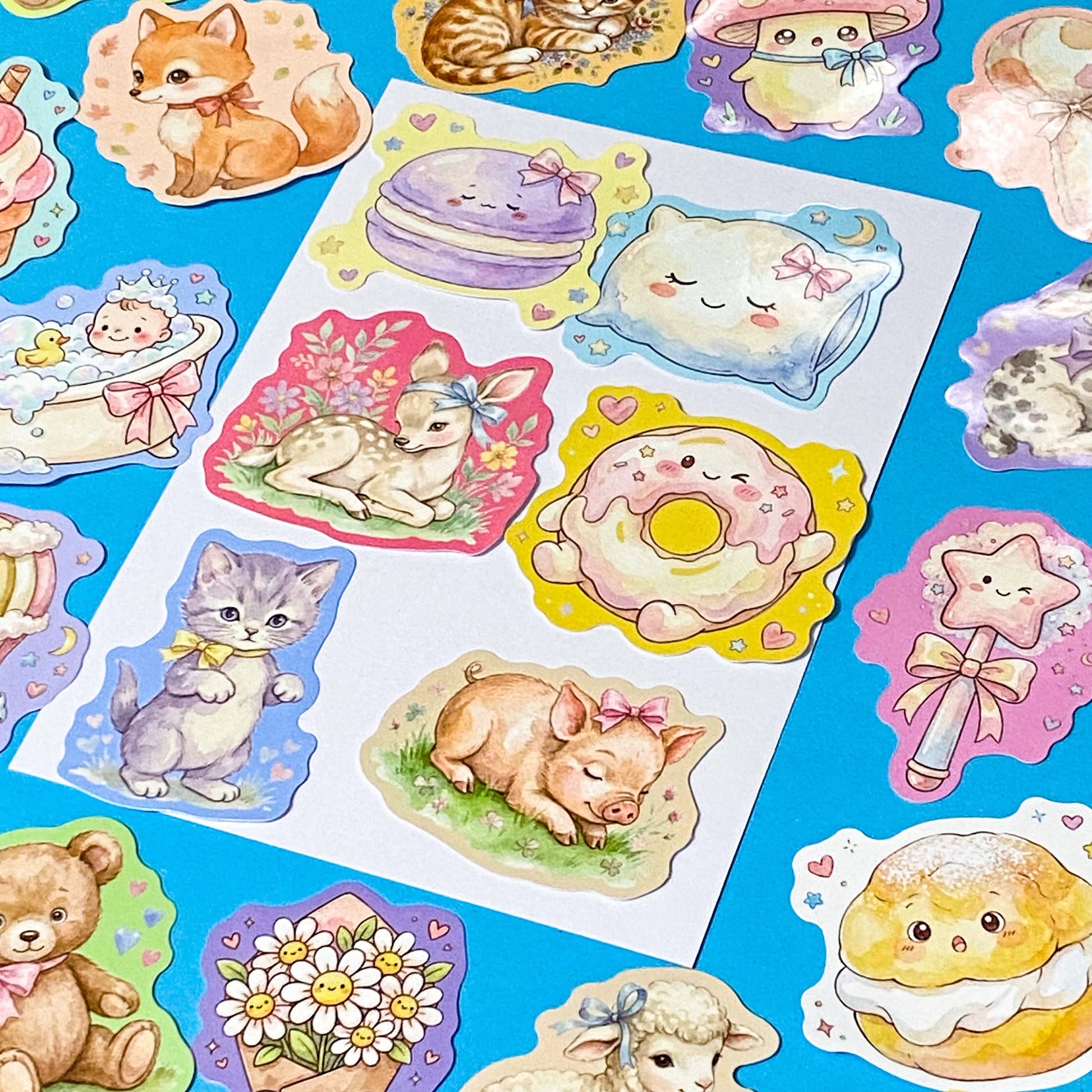 pack of 50 glossy pastel storybook stickers featuring baby animals, woodland creatures, sweet desserts and cakes, cosy drinks and whimsical kawaii illustrations, approx 53mm each. 
