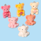 teddy bear and elephants resin flocked charms on a blue background