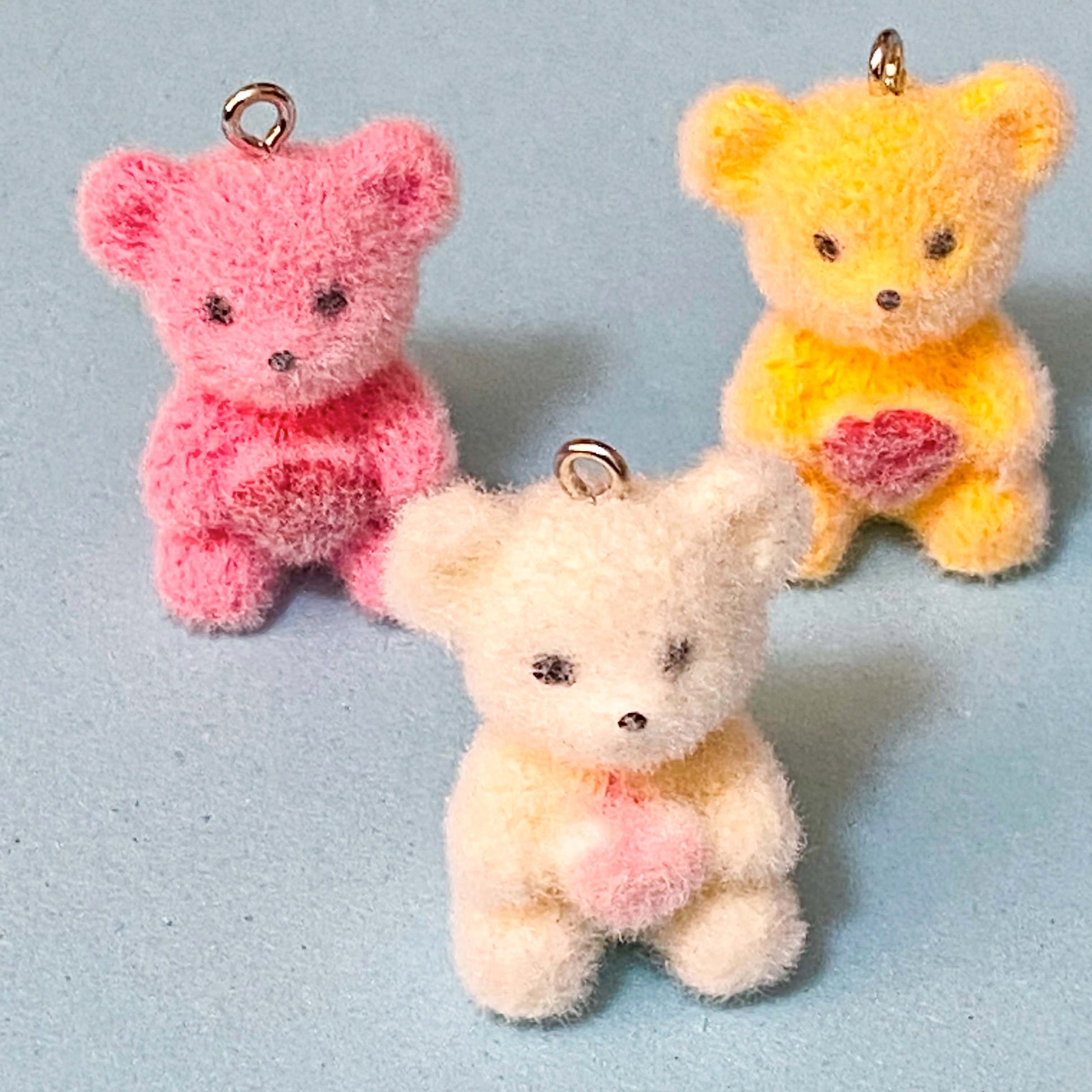 teddy bear flocked resin charms on a blue background