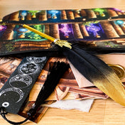 vintage apothecary writing set with black feather pen, celestial bookmark and pouch on wooden background 