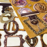 set of 68 vintage style clear PET stickers featuring ornate frames, antique keys, wax seals and clockwork designs in warm sepia tones on layered backing sheets