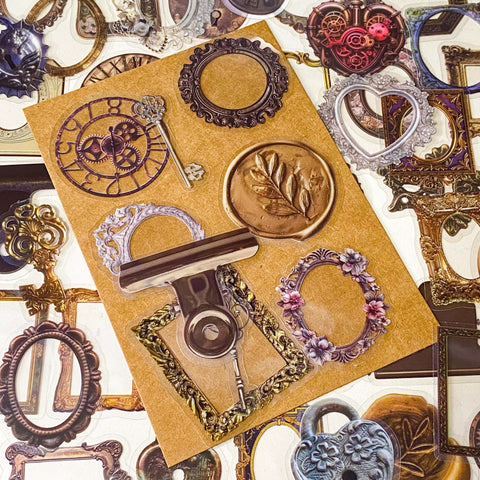 set of 68 vintage style clear PET stickers featuring ornate frames, antique keys, wax seals and clockwork designs in warm sepia tones on layered backing sheets