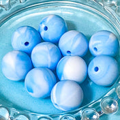 Blue marbled silicone large beads in a clear glass bowl