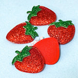glittery red strawberry fabric appliques on a blue background