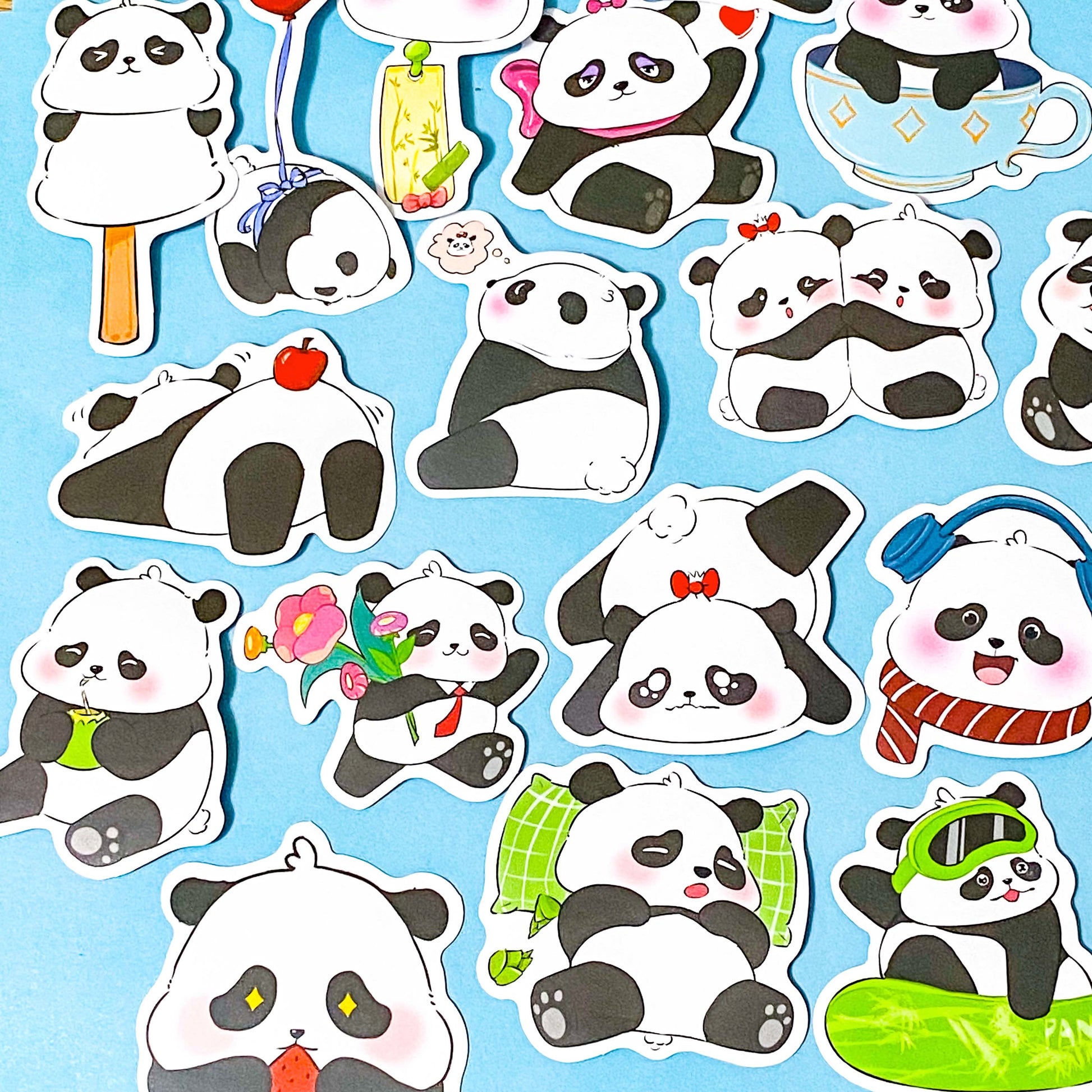 Stickers of cartoon pandas with various poses and accessories on a blue background