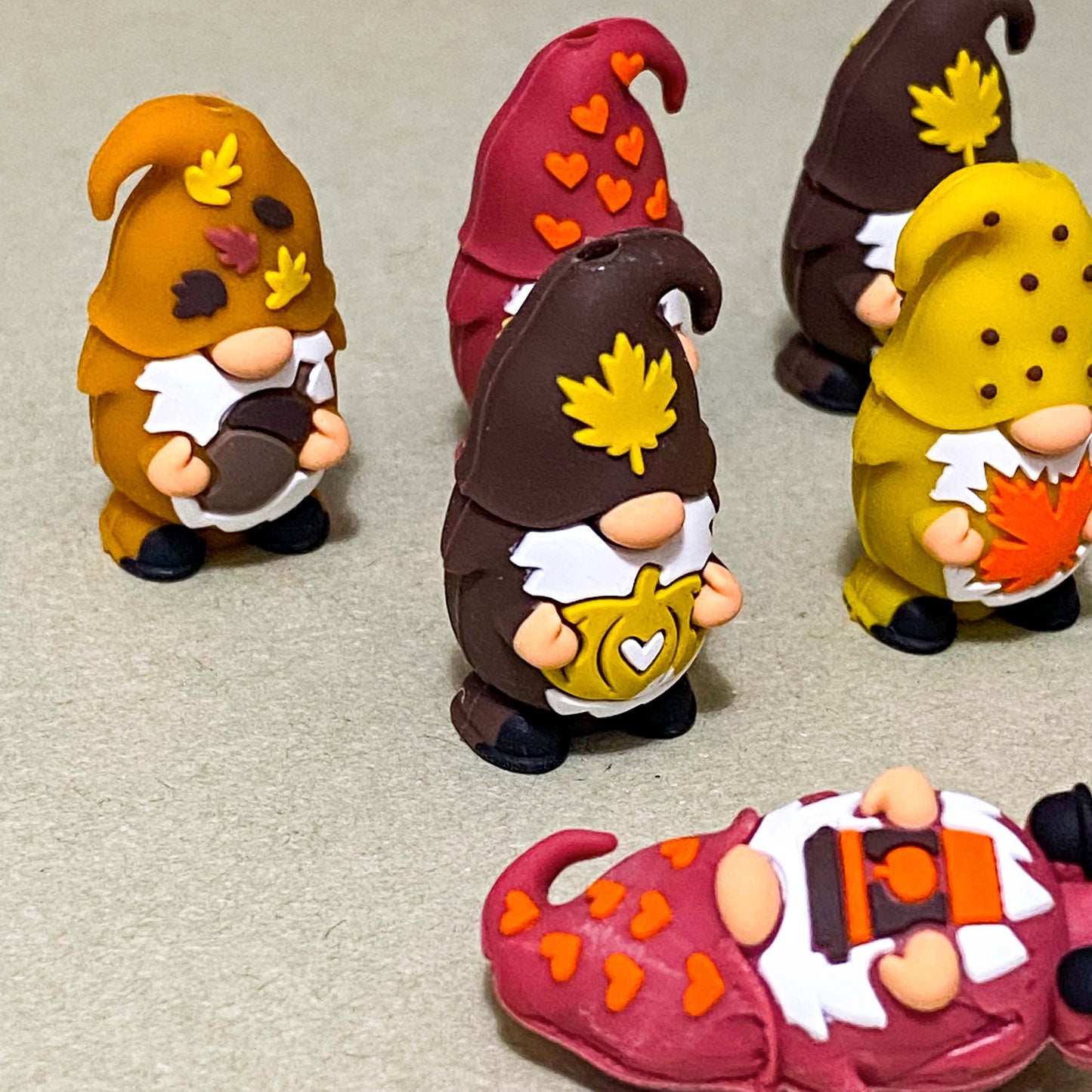 autumn cosy gnome silicone jumbo chunky bead with large hole for beaded pen making. orange, dark red and brown. hearts, coffee cup, pumpkins,  leaves and acorns. uk cute crafts supplies shop.