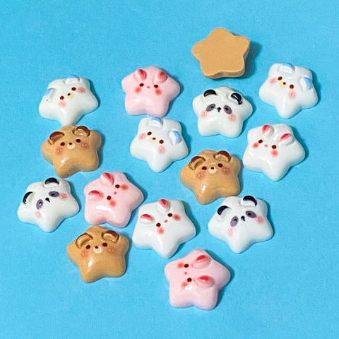 small 15mm resin star flatbacks with cute puppy dog, panda, bear and bunny faces on them on a blue background