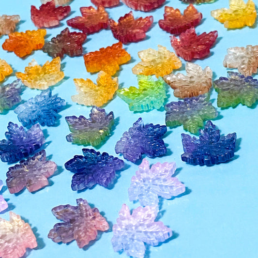 17mm glass maple leaf beads on a blue background