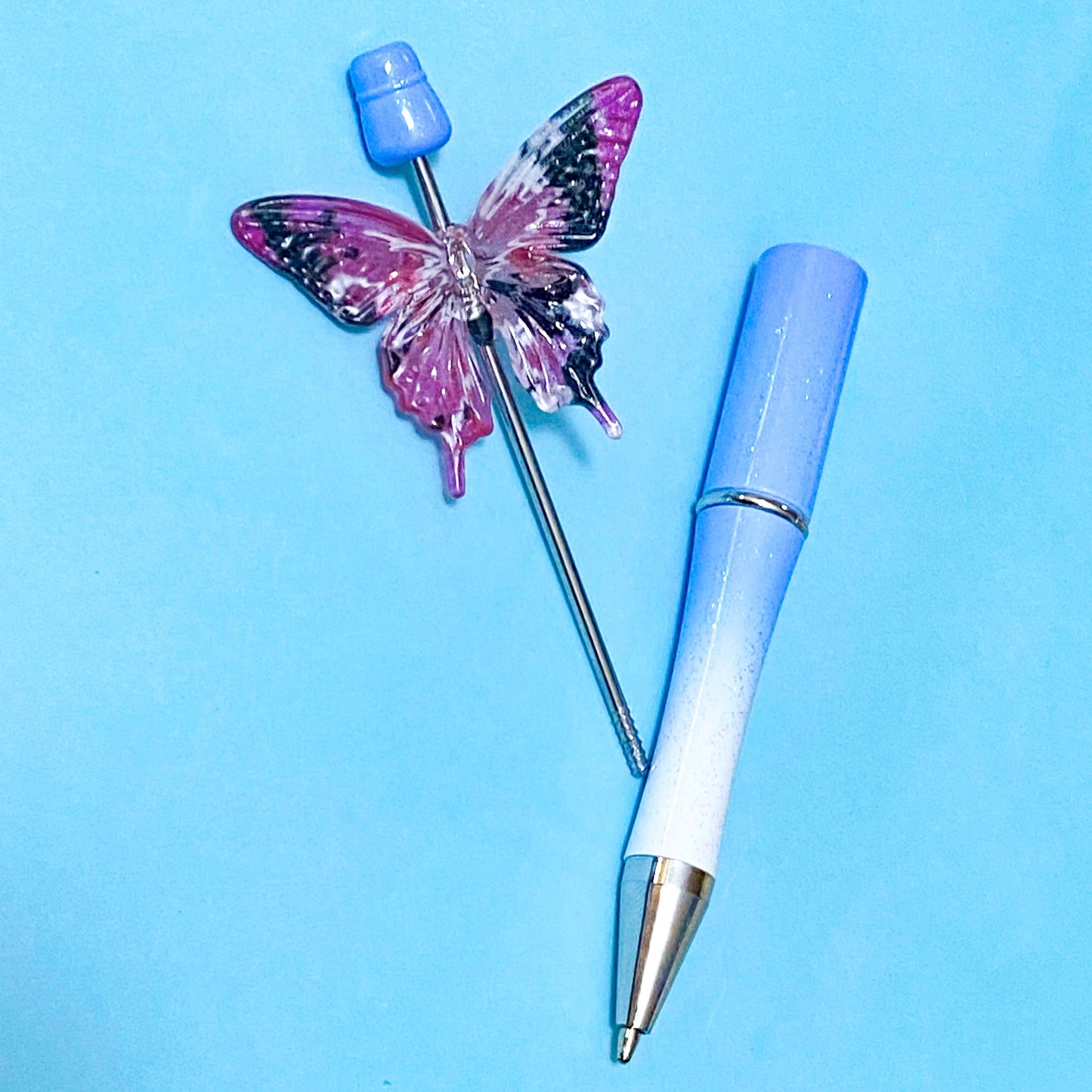 very large butterfly acrylic bead on a blue pen base
