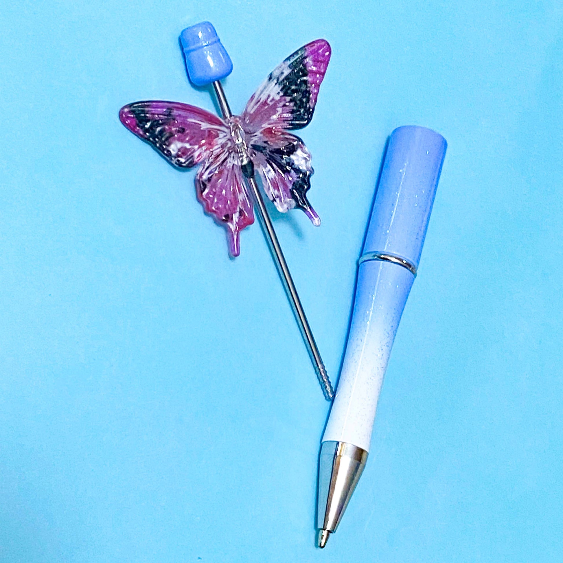 very large butterfly acrylic bead on a blue pen base