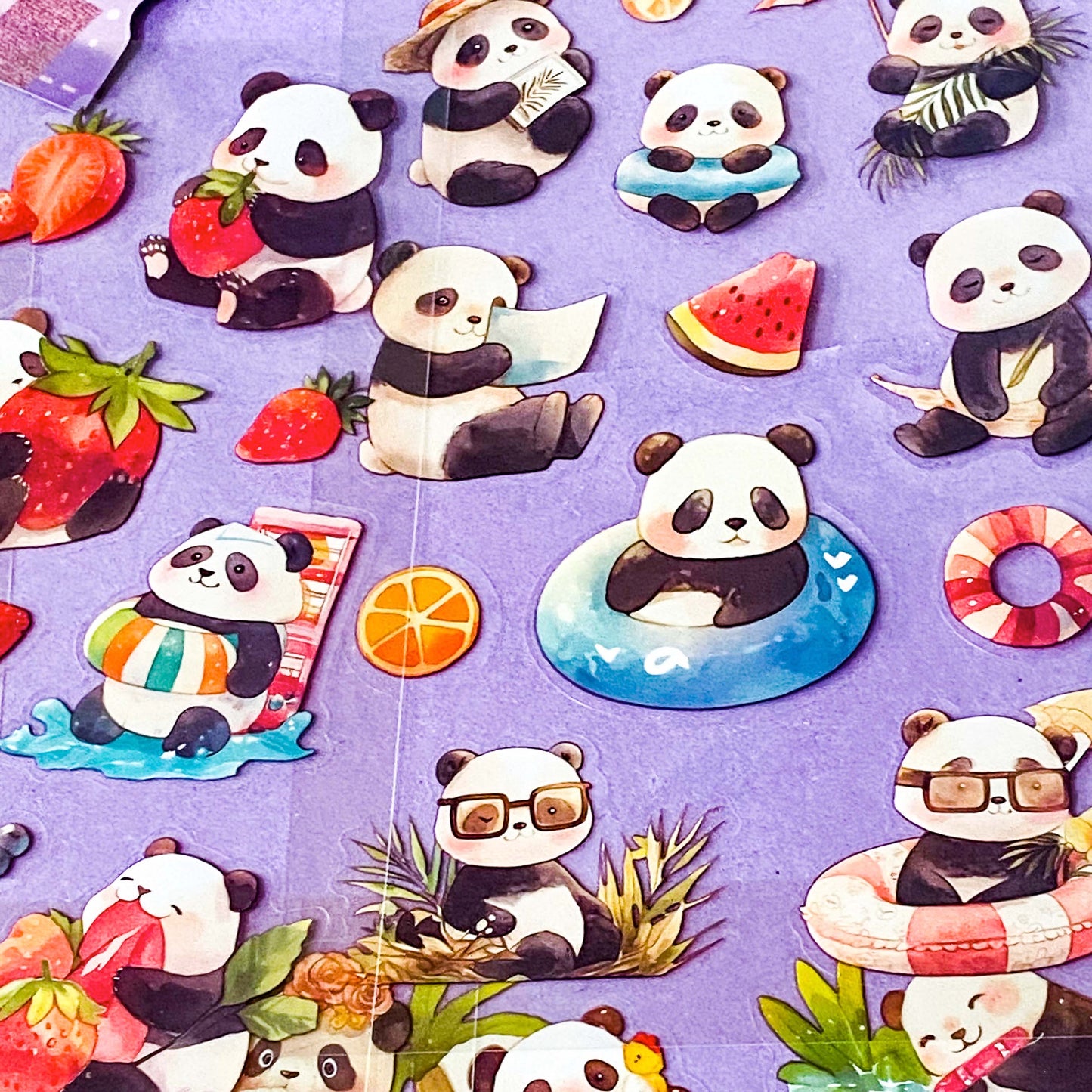 close up of clear plastic sticker sheets with cute panda illustrations on a purple background