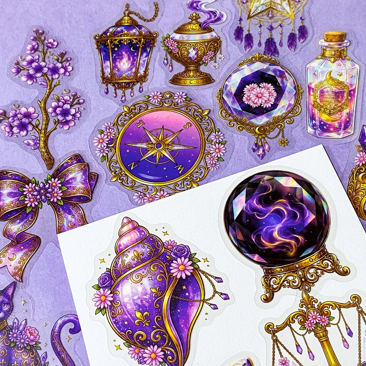 50 different violet oracle witchcore peT stickers featuring crystal balls, tarot cards, butterflies, celestial eyes, candle, skull, moons, potions, flowers, magical purple illustrations. uk stationery gift shop.