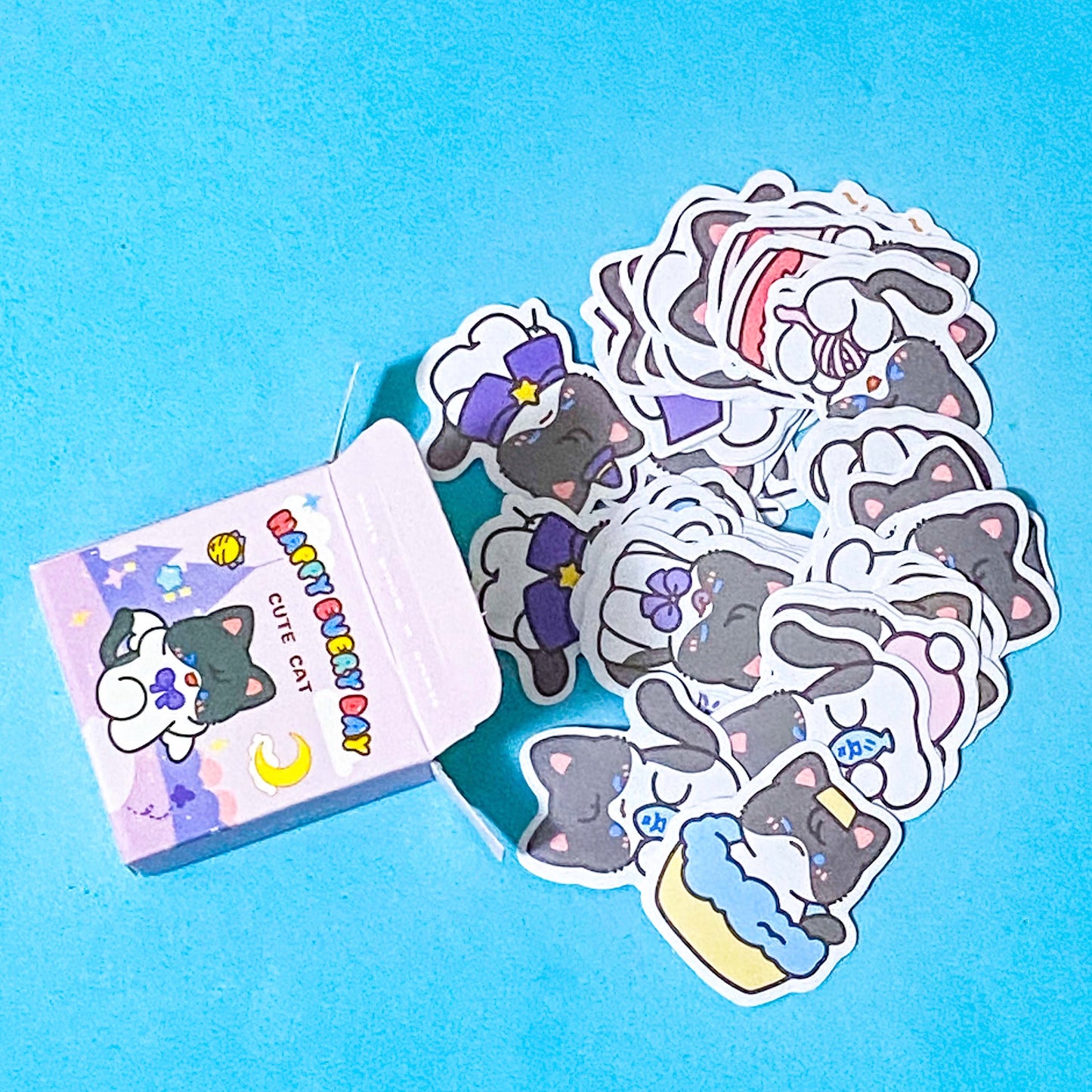 Set of cute cat-themed stickers with a small box on a blue background