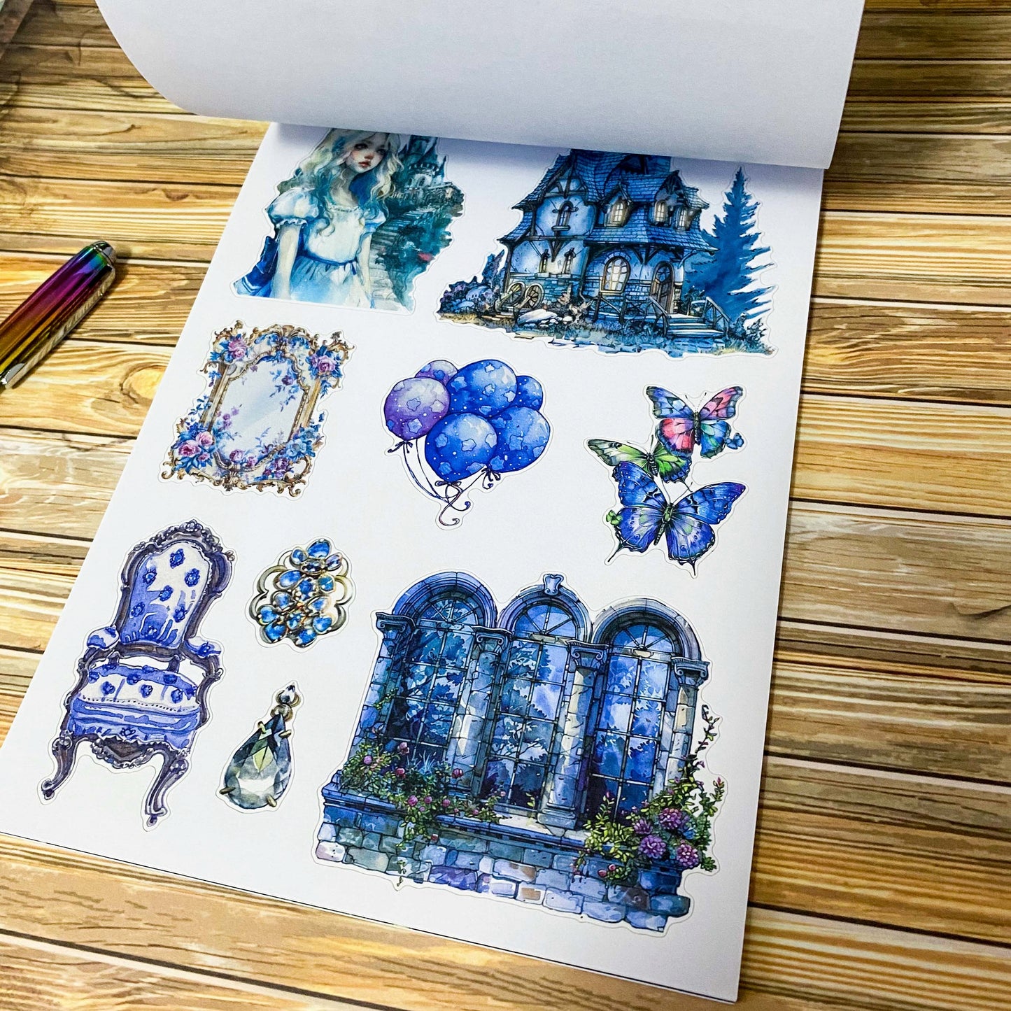 large Alice's Journey paper sticker book featuring 20 big matte pages of wonderland inspired fantasy stickers with castles, mushrooms, florals, vintage frames and blue fairytale illustrations