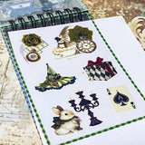 small spiral bound curiouser and curiouser alice clear PET sticker folio featuring fantasy stickers with mushrooms, roses, playing cards, rabbits and vintage gothic fairytale artwork