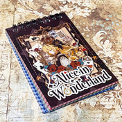 small spiral bound curiouser and curiouser alice clear PET sticker folio featuring fantasy stickers with mushrooms, roses, playing cards, rabbits and vintage gothic fairytale artwork