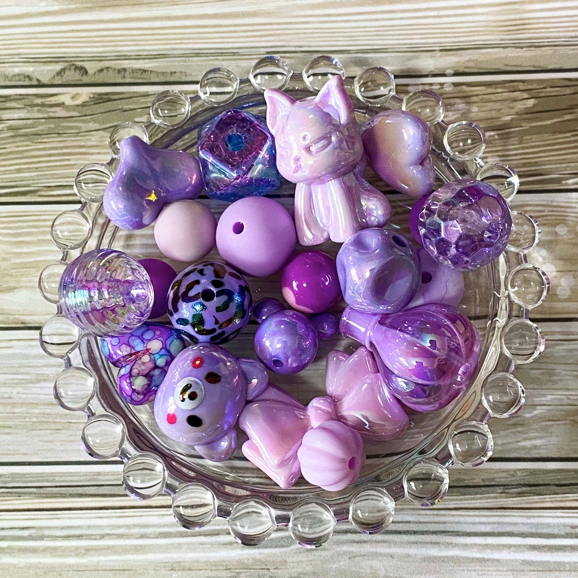 large purple and lilac acrylic and silicone beads bundle of 22 with designs including bear, cat, hot air balloon and bow. For making beaded pens and jewellery. `uk crafts bundle. Pretty beading kit.