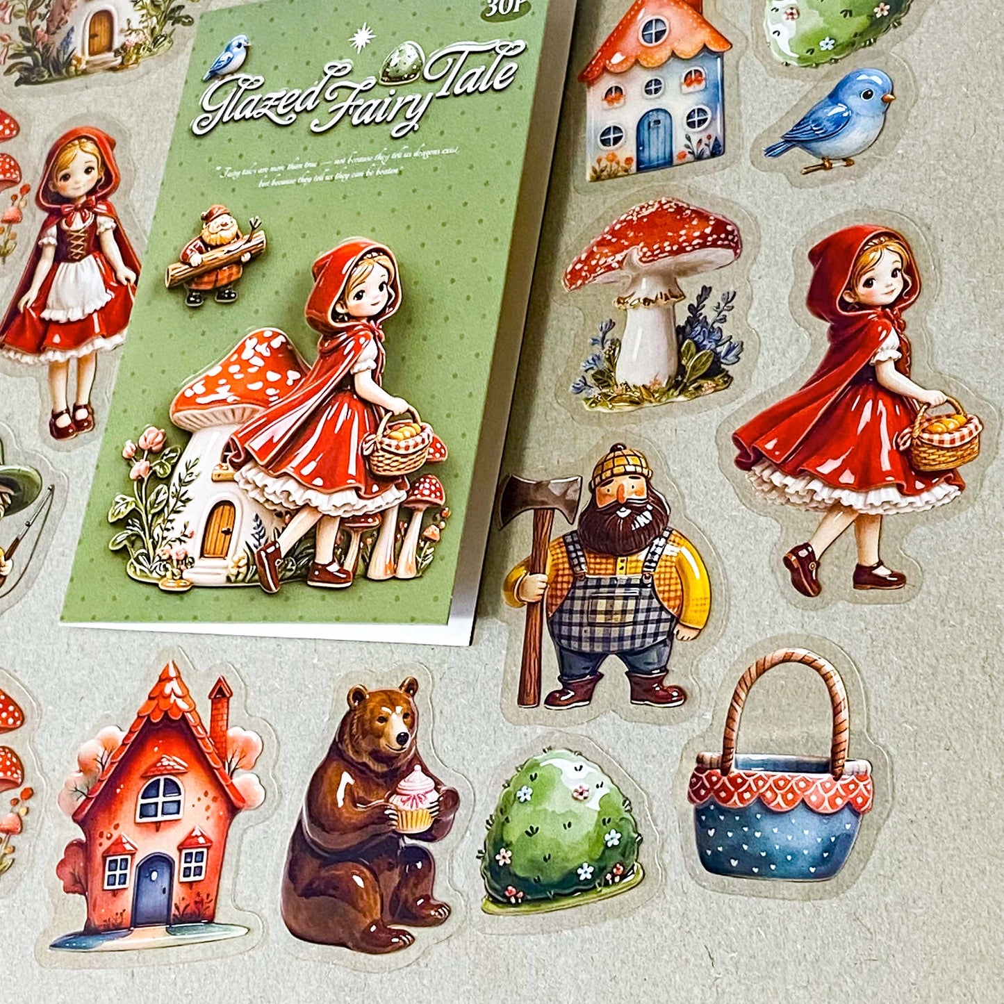 little red riding hood ceramic glazed clear PET sticker set of 30 designs including girl, cottage, mushrooms, basket, raccoon, brown bear, blue bird and woodcutter. Uk cute stationery shop.