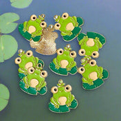 frog frogs on lily pad pads green gold tone golden enamel enamelled charm charms pendant pendant kawaii cute craft supplies shop uk jewellery making big eyes metal