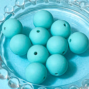 soft pale turquoise silicone 15mm round beads on a blue background