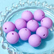 lilac soft silicone 15mm round beads on a blue background