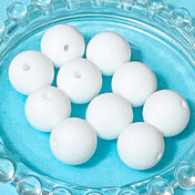 white round silicone 15mm soft beads on a blue background