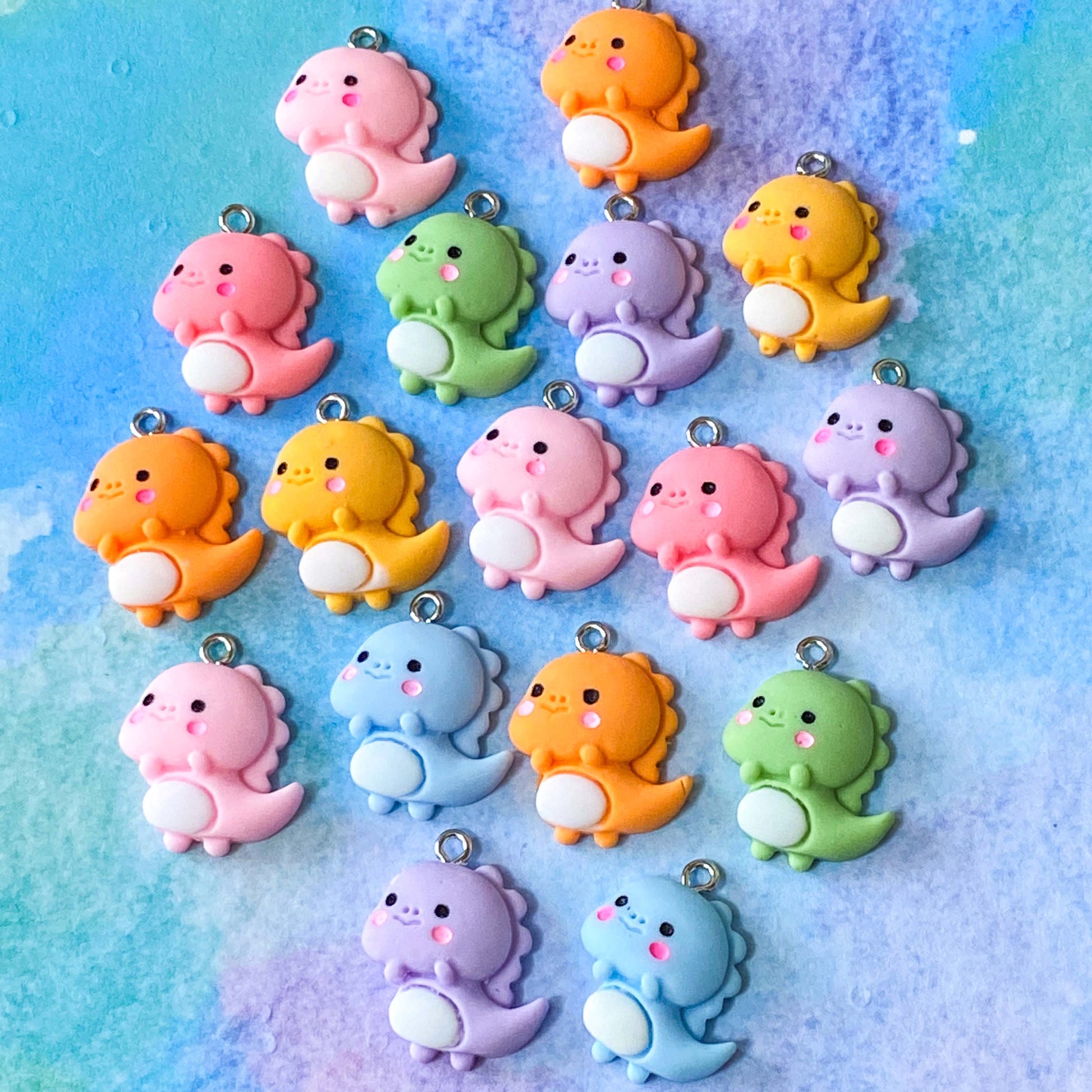 baby cute kawaii dino dinos dinosaur dinosaurs charm charms resin pendant uk craft supplies shop store pretty fun jewellery making lilac pink orange green yellow 