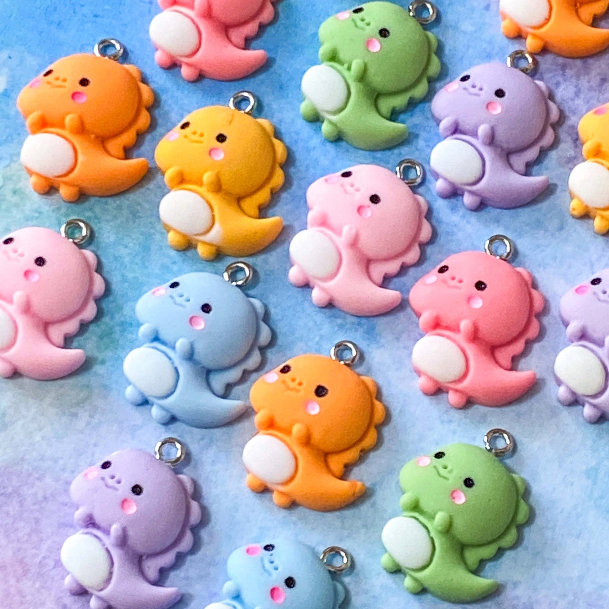 baby cute kawaii dino dinos dinosaur dinosaurs charm charms resin pendant uk craft supplies shop store pretty fun jewellery making lilac pink orange green yellow