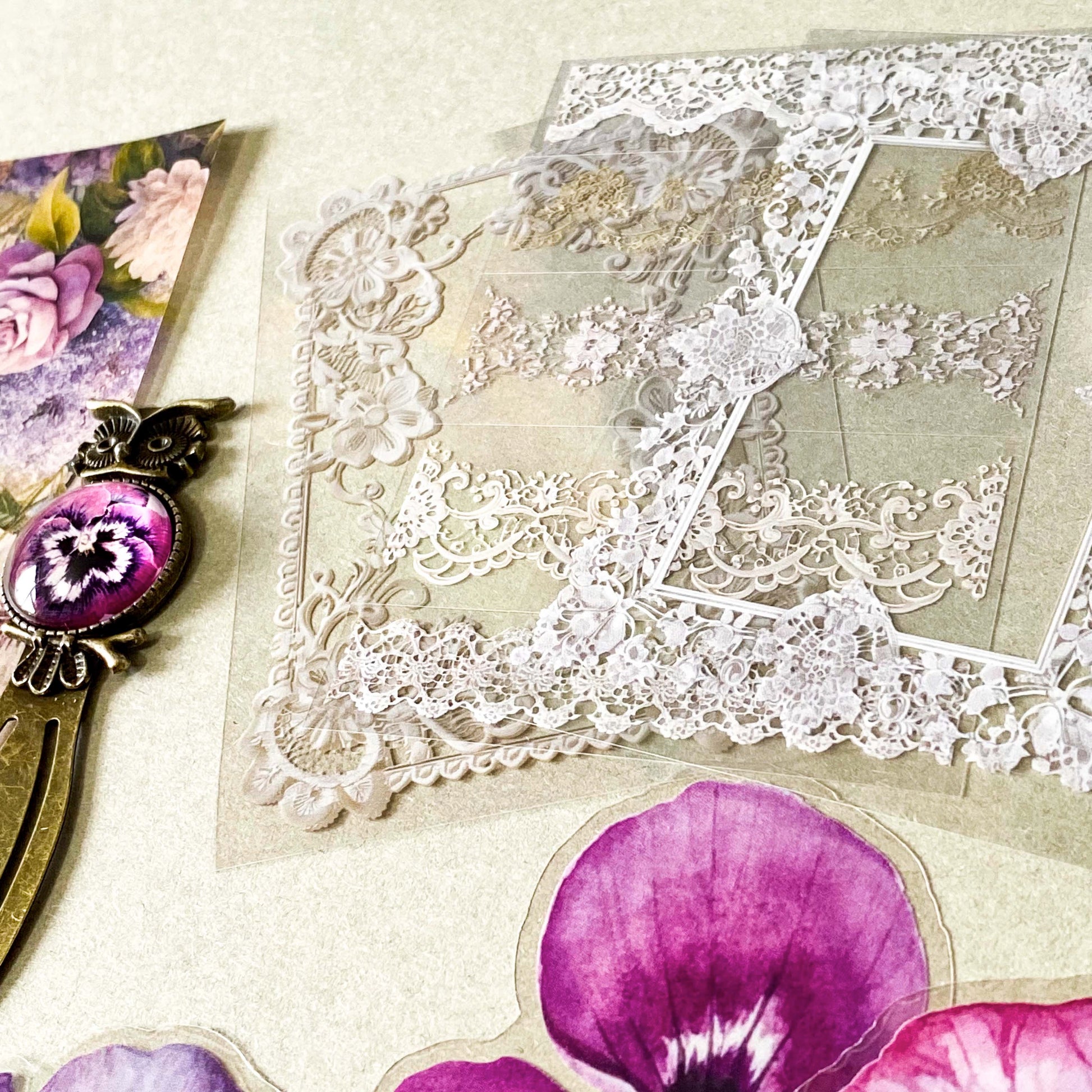 victorian pansy themed letterbox gift set with floral pouch, botanical stickers, vellum journaling sheets and antique style metal and glass bookmark in shades of purple, yellow and blue