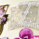 victorian pansy themed letterbox gift set with floral pouch, botanical stickers, vellum journaling sheets and antique style metal and glass bookmark in shades of purple, yellow and blue